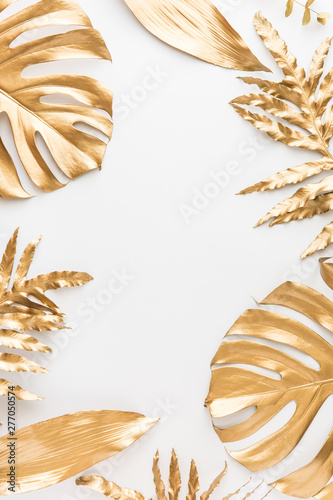 Flat lay of golden tropical leaf design elements. Decoration elements for inv...