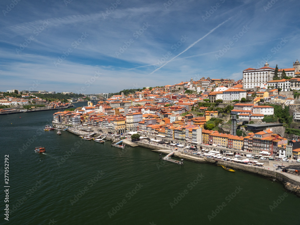 Portugal, June 2019: Porto Cityscape over Douro River and medieval Ribeira district, Portugal. One of the oldest European centres, its historical core was proclaimed a World Heritage Site by UNESCO.