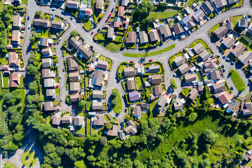 Aerial drone view of small winding sreets and roads in a residential area of a small town photo