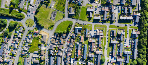 Fototapeta Naklejka Na Ścianę i Meble -  Aerial drone view of small winding sreets and roads in a residential area of a small town