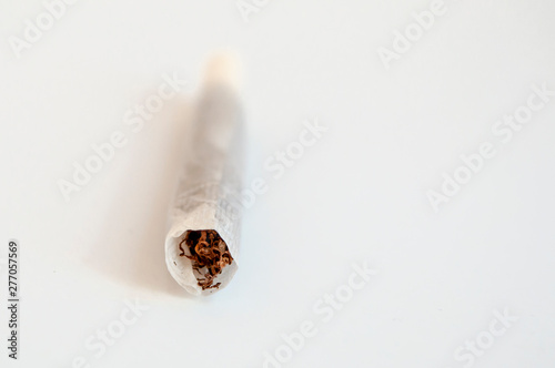 Clean up front shoot of handmade single cigarette horizontal positioned
