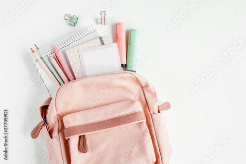 Backpack with school supplies and books for study. Back to school concept. Flat lay, top view photo