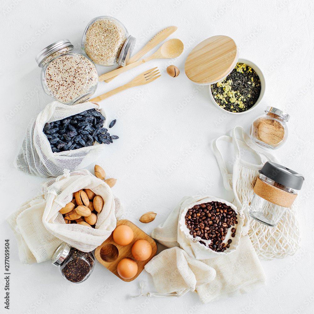 Nuts, dried fruits and groats in eco cotton bags and glass jars on white table in the kitchen. Zero Waste Food Shopping. Waste-free living Nuts, dried fruits and groats in eco cotton bags and glass jars on white table in the kitchen. Zero Waste Food Shopping. Waste-free living