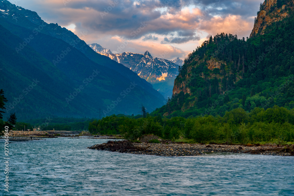 The river flows in a deep gorge, the mountains of Caucasus.