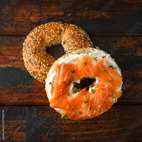 Tableau sur toile Bagels breakfast sandwich with Cream cheese and salmon on wooden table