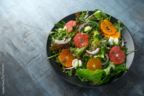 Orange and grapefruit Citrus salad with lentills vertes, wild rocket, arugula, red onion and sprinkle of pumpkin seeds photo