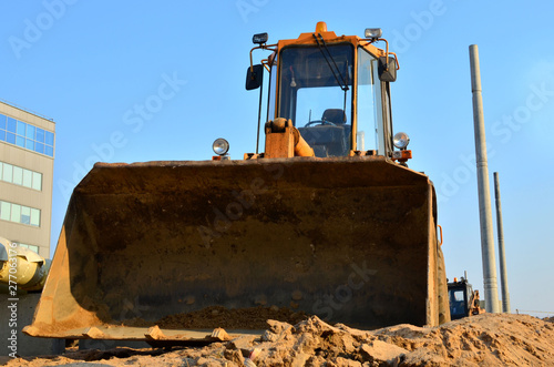 Huge iron bucket front loader close up at a construction site