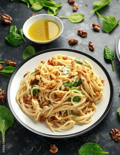 Pasta with roasted walnut, ricotta white pesto sauce, parmesan cheese and spinach