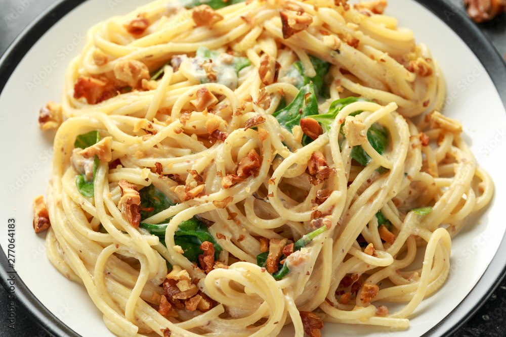 Pasta with roasted walnut, ricotta white pesto sauce, parmesan cheese and spinach Pasta with roasted walnut, ricotta white pesto sauce, parmesan cheese and spinach