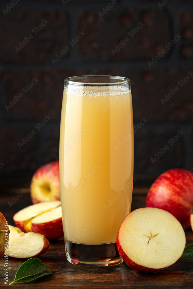 Apple juice in glass on rustic wooden table Apple juice in glass on rustic wooden table