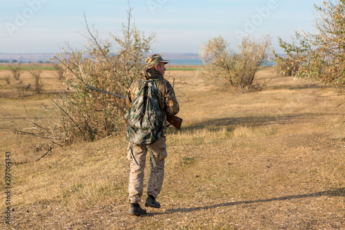 Hunter with a german drathaar and spaniel  pigeon hunting with dogs in reflective vests 