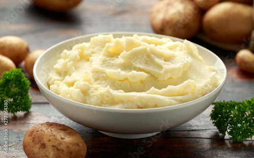 Vászonkép Mashed potatoes in white bowl on wooden rustic table