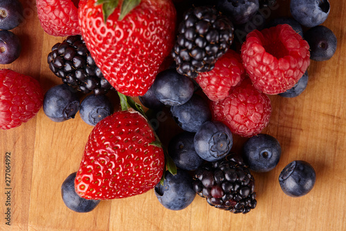 Various fresh summer berries. Ripe strawberries  blackberries  blueberries  raspberries. Top view. Background berries and fruits