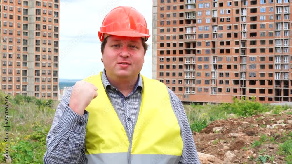 Male builder foreman, worker or architect on construction building site threatening his fist Male builder foreman, worker or architect on construction building site threatening his fist