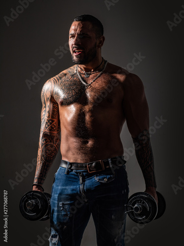 There is no limit to perfection. Work out concept. Macho confident face with muscular body sportsman bodybuilder. Muscular macho six packs hold dumbbells. Guy attractive working out. Muscular torso