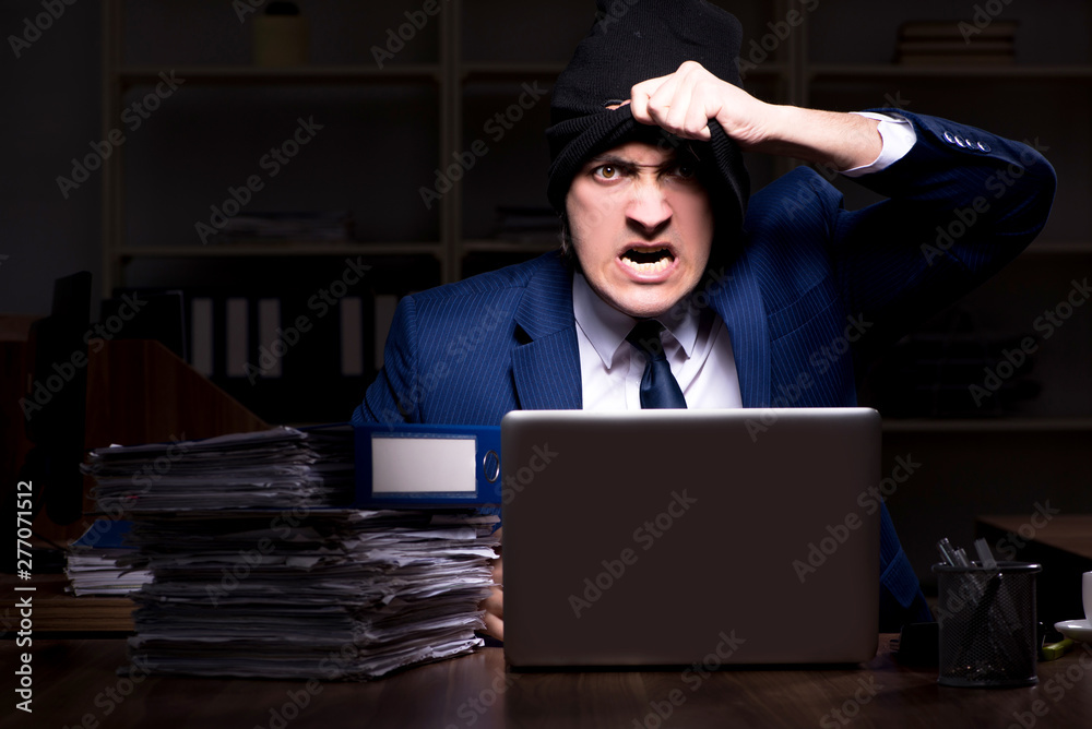 Male employee stealing information in the office night time Male employee stealing information in the office night time