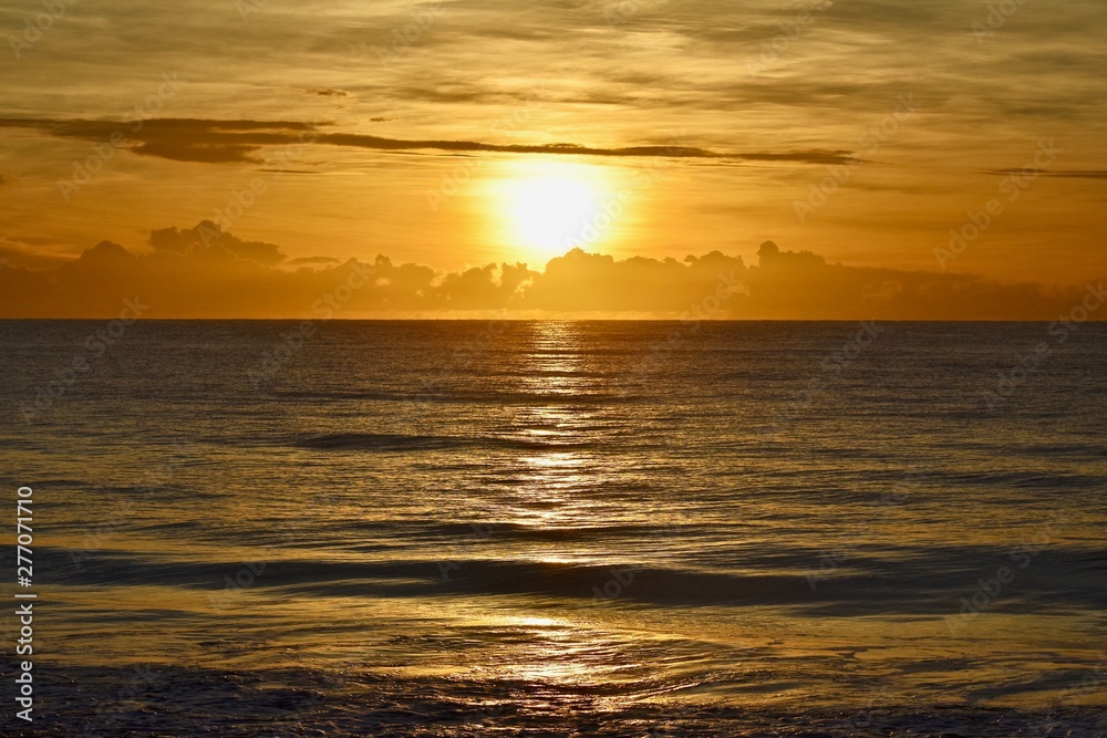 Obraz premium Sunrise over ocean and clouds