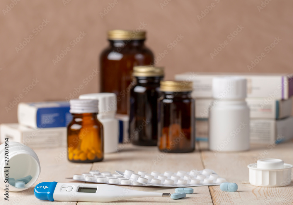 A group of boxes of medicines, pill bottles, thermometer and blisters of pills A group of boxes of medicines, pill bottles, thermometer and blisters of pills