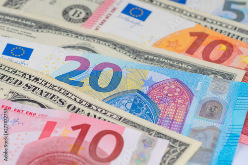 many different american dollars and european union euro banknotes close-up shot