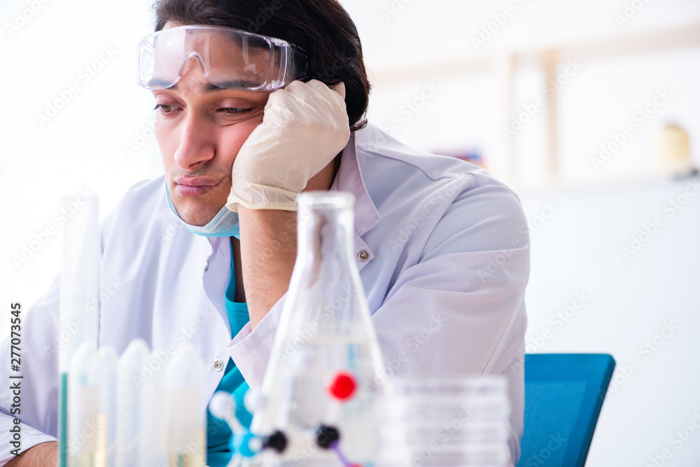 Young male chemist working in the lab 