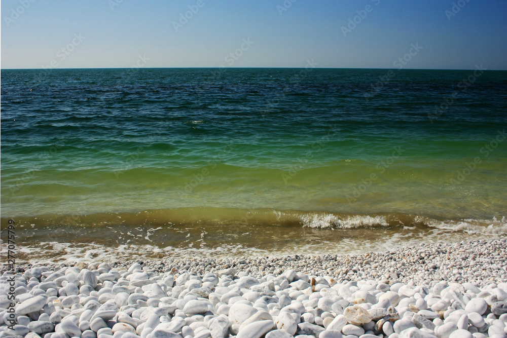 Green waves of the sea lapping on the shore