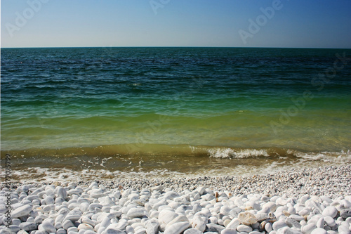 Green waves of the sea lapping on the shore