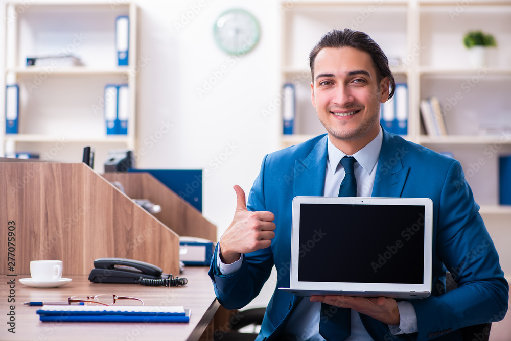 Young handsome businessman sitting in the office Young handsome businessman sitting in the office