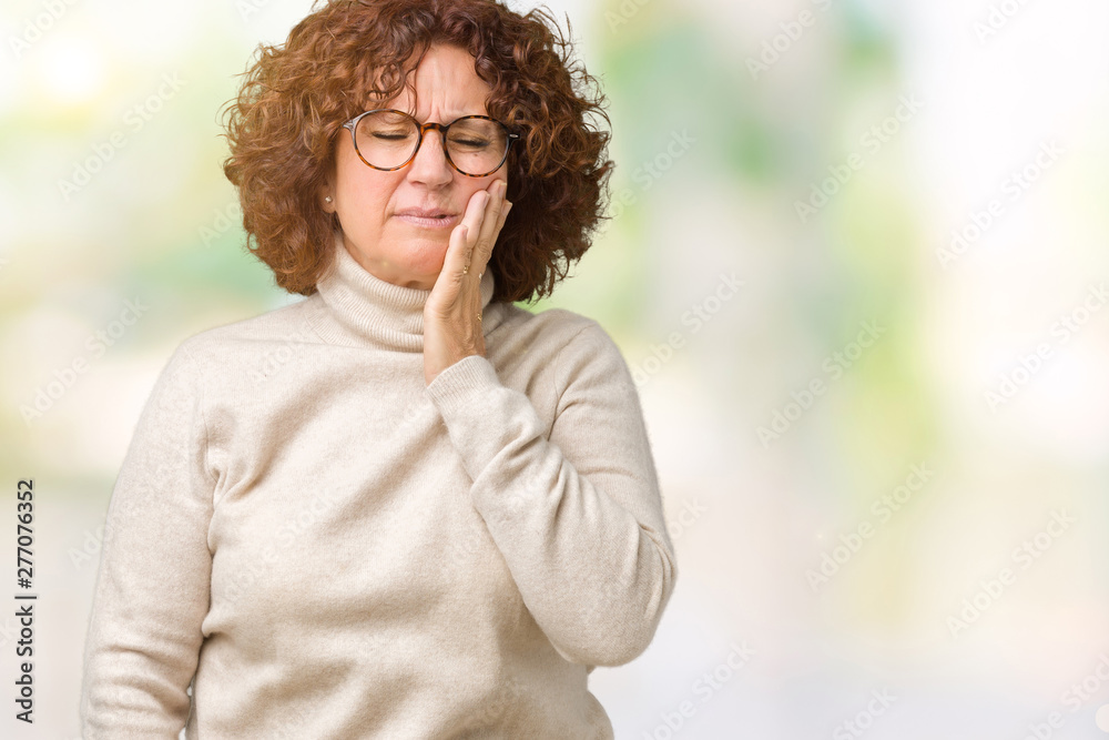 Beautiful middle ager senior woman wearing turtleneck sweater and glasses over isolated background touching mouth with hand with painful expression because of toothache or dental illness on teeth. Beautiful middle ager senior woman wearing turtleneck sweater and glasses over isolated background touching mouth with hand with painful expression because of toothache or dental illness on teeth.