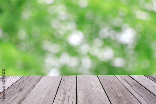 Old wooden floor with green blur background.