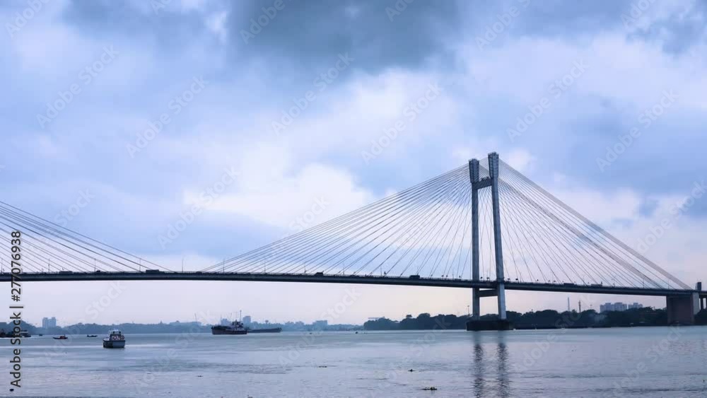 4K Timelapse beautiful clouds over Kolkata city with a view of Vidyasagar Bridge or Seconf Hooghly Bridge on the Ganges river, West Bengal, India.