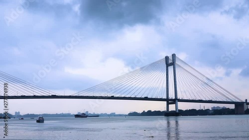 4K Timelapse beautiful clouds over Kolkata city with a view of Vidyasagar Bridge or Seconf Hooghly Bridge on the Ganges river, West Bengal, India. photo