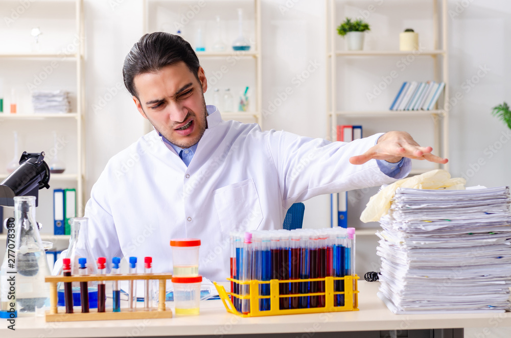 Young male chemist working in the lab 