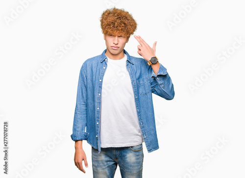 Canvas Print Young handsome man with afro hair wearing denim jacket Shooting and killing oneself pointing hand and fingers to head, suicide gesture