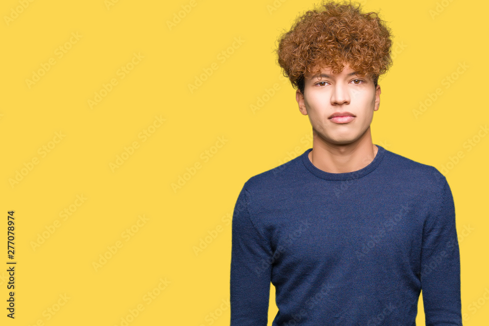 Young handsome man with afro hair Relaxed with serious expression on face. Simple and natural looking at the camera. Young handsome man with afro hair Relaxed with serious expression on face. Simple and natural looking at the camera.