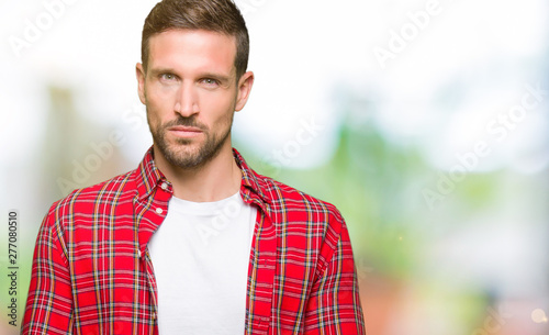 Handsome man wearing casual shirt skeptic and nervous, frowning upset because of problem. Negative person.