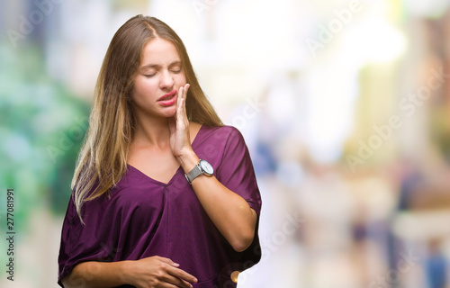 Young beautiful blonde elegant woman over isolated background touching mouth with hand with painful expression because of toothache or dental illness on teeth. Dentist concept.