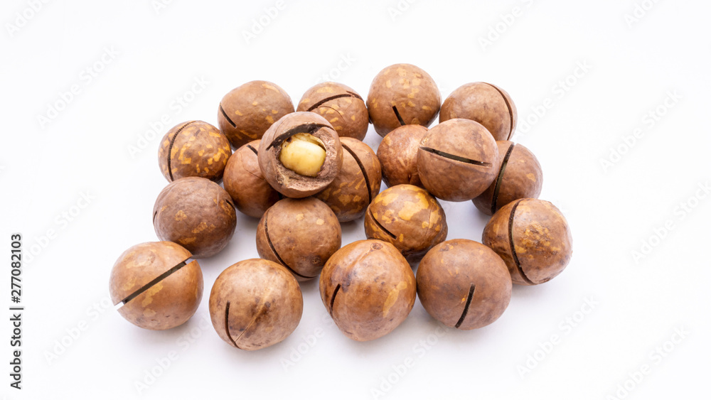 Fruits of the Australian macadamia nut on a white background. Kernels with a Shelled Shell Fruits of the Australian macadamia nut on a white background. Kernels with a Shelled Shell