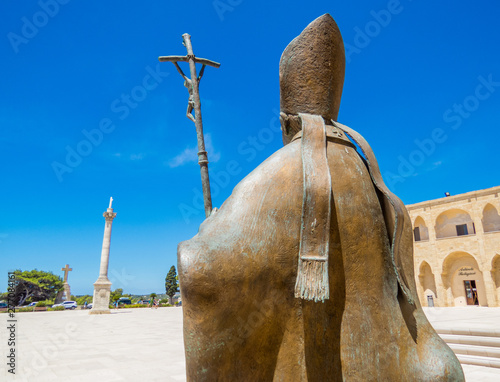 Canvas Print SANTA MARIA DI LEUCA, ITALY - JULY 17, 2017: Pope Benedict XVI bronze statue with view on the main city square