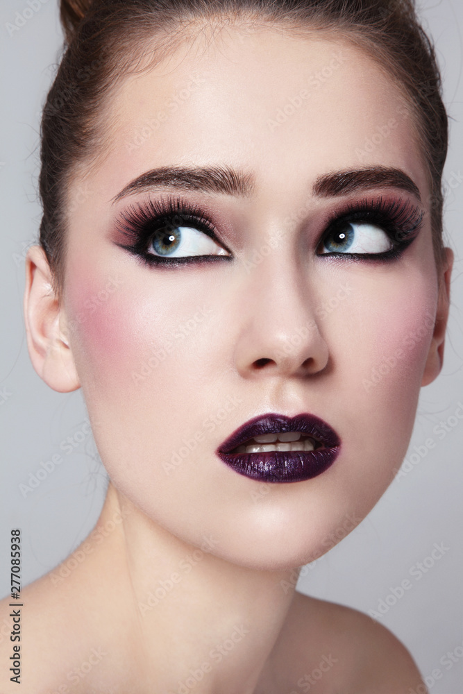 Portrait of young beautiful girl with fancy winged eye makeup