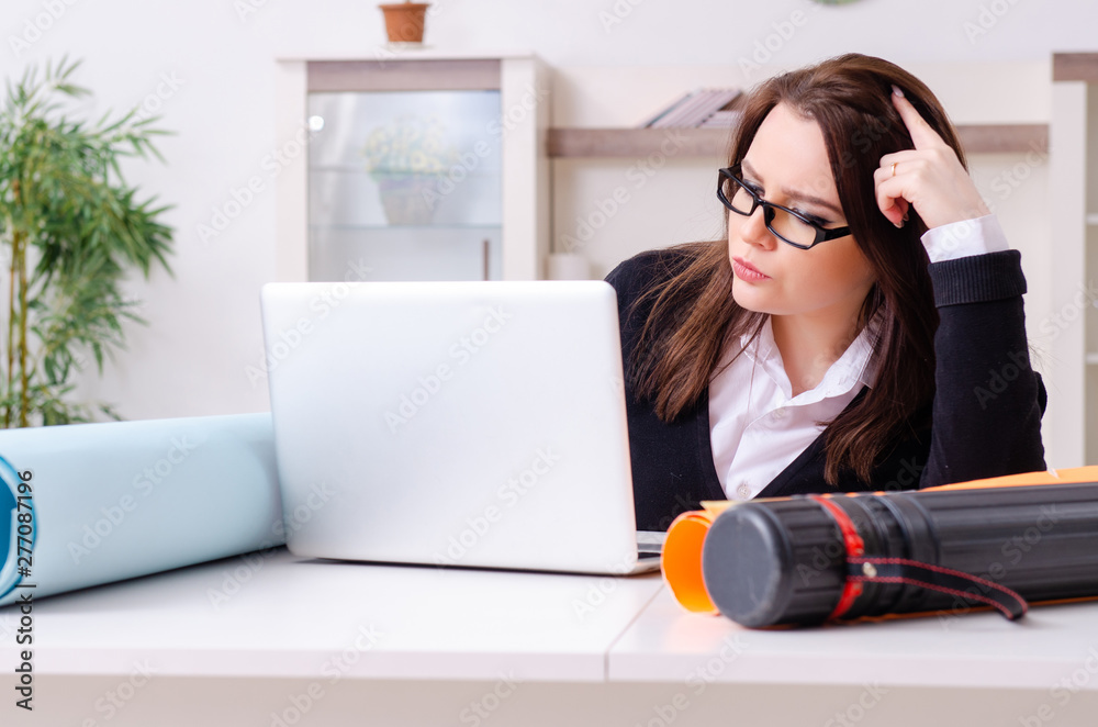 Female designer working in the office Female designer working in the office