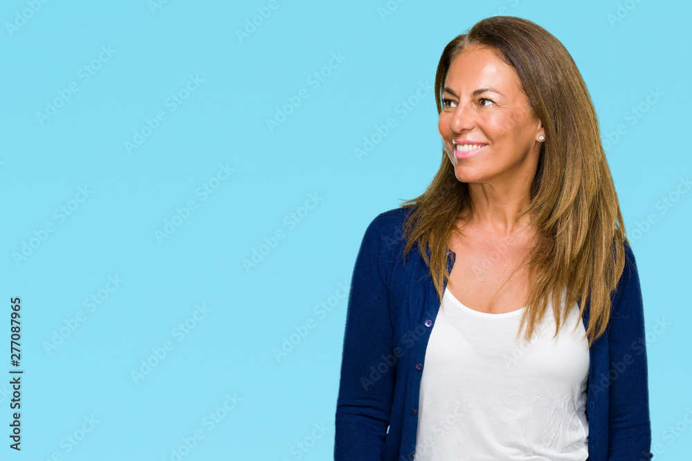 Beautiful middle age casual adult woman over isolated background looking away to side with smile on face, natural expression. Laughing confident. Beautiful middle age casual adult woman over isolated background looking away to side with smile on face, natural expression. Laughing confident.