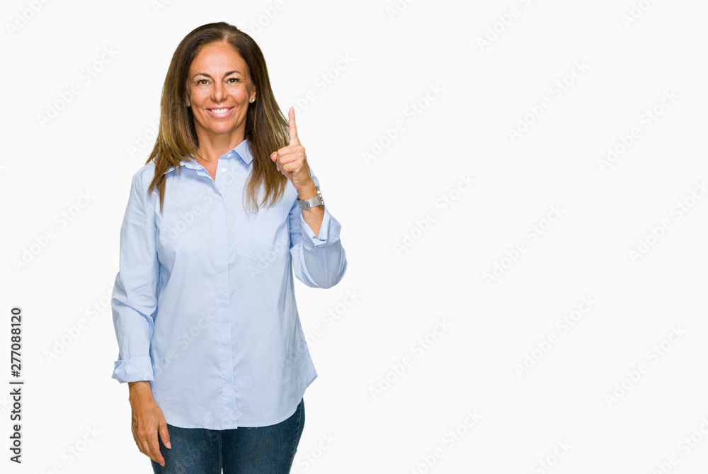 Beautiful middle age business adult woman over isolated background showing and pointing up with finger number one while smiling confident and happy. Beautiful middle age business adult woman over isolated background showing and pointing up with finger number one while smiling confident and happy.