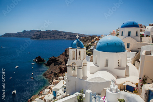 Oia town on Santorini island  Greece. View of traditional white houses and churches with blue domes over the Caldera