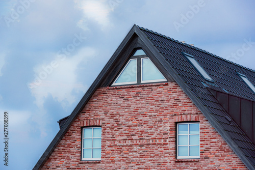 Frisian house roof and red-brick wall