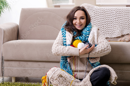 Young beautiful woman knitting at home 