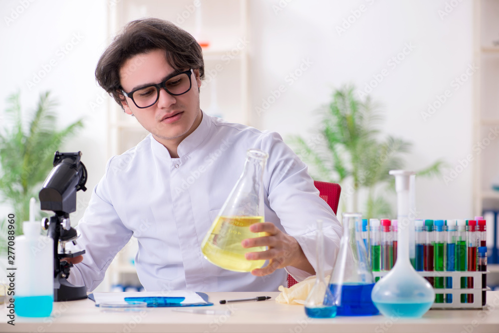 Young male biochemist working in the lab Young male biochemist working in the lab