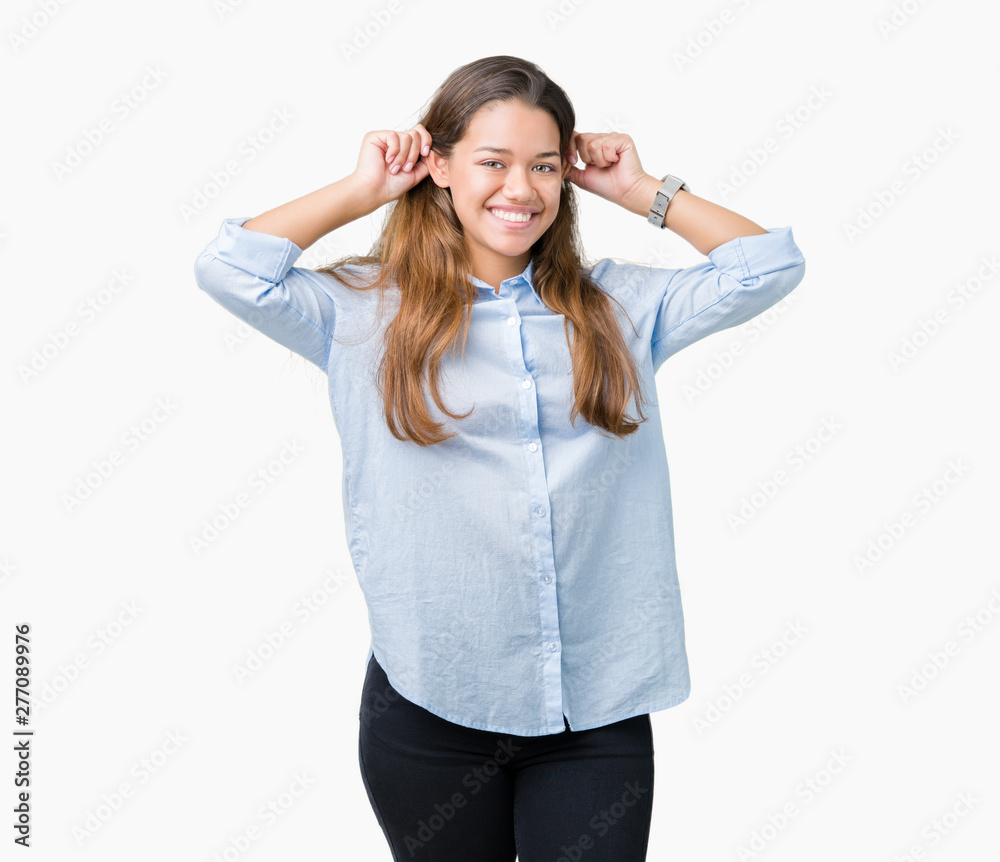 Young beautiful brunette business woman over isolated background Smiling pulling ears with fingers, funny gesture. Audition problem Young beautiful brunette business woman over isolated background Smiling pulling ears with fingers, funny gesture. Audition problem