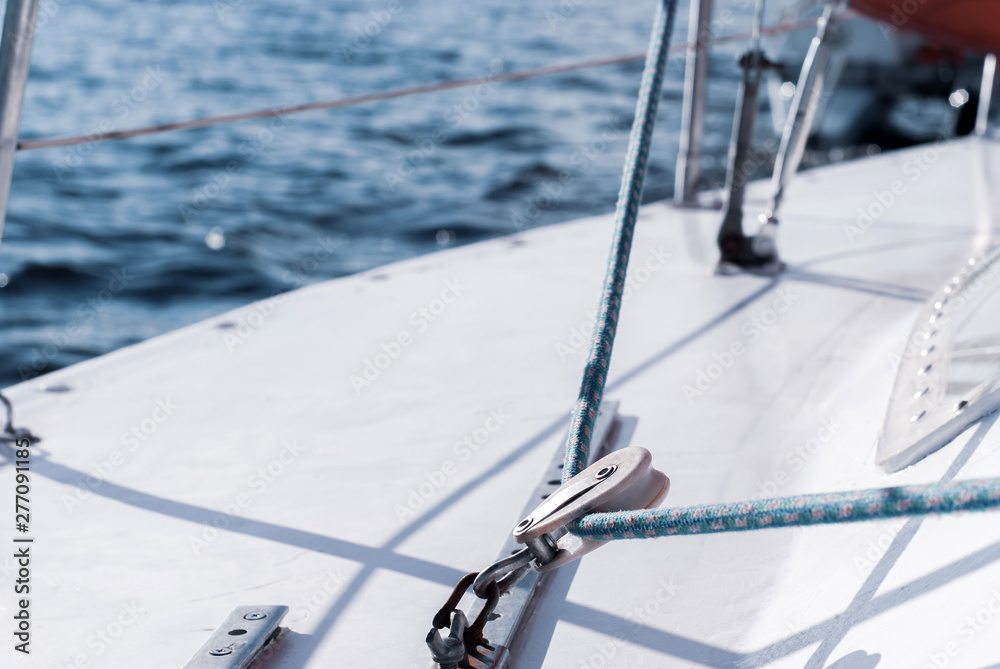 Fototapeta premium background - yachting. fragment of the hull of a sailing vessel with rigging against the backdrop of water