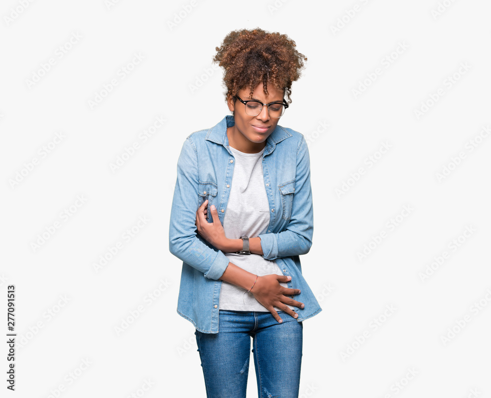 Beautiful young african american woman wearing glasses over isolated background with hand on stomach because nausea, painful disease feeling unwell. Ache concept. Beautiful young african american woman wearing glasses over isolated background with hand on stomach because nausea, painful disease feeling unwell. Ache concept.
