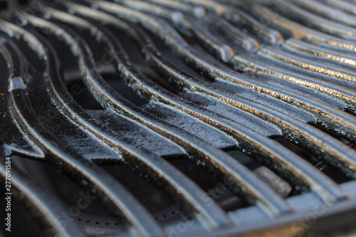 shiny black grill or cooking grid on a gas grill, cleaned and oiled to start a barbecue